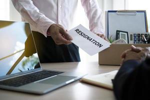 businessman have boxes for personal use and are sending resignation letters to executives. Including about resignation from job positions and vacancies. photo