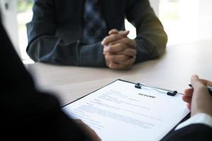 Executives are interviewing candidates. Focusing on resume writing tips, applicant qualifications, interview skills and pre-interview preparation. Considerations for new employees photo