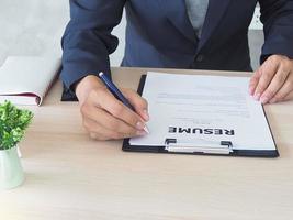 Managers are checking out the cover letter. By sitting on his desk. Resume concept photo