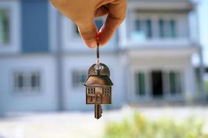 Landlord unlocks the house key for new home photo