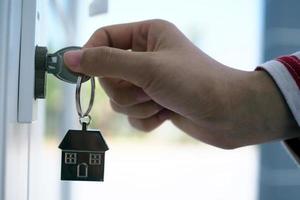 Landlord unlocks the house key for new home photo