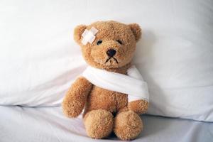 Teddy bear and bandage. Injury concept photo