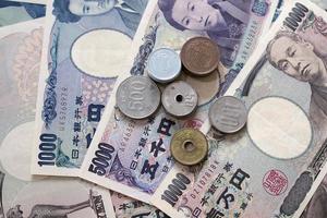 Japanese yen notes and Japanese yen coins for money concept background. photo