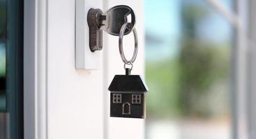 The house key for unlocking a new house is plugged into the door. photo