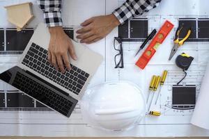 The work desk of the project contractor or engineer viewing the building structure plan photo