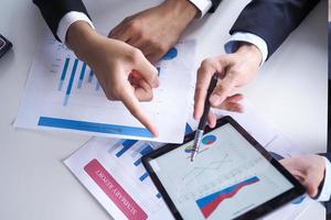 The two businessmen consulted about the operating results of the joint venture business, with statistical documentation. photo