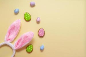 Happy easter. Pastel colors Easter eggs with cookies on beige background. photo