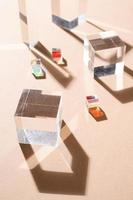 Glass prisms reflect light making beautiful shadows on beige background photo