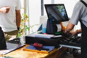 Woman csahing at counter service changing money for customer. photo