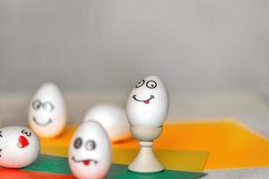 stickers with different emotions are pasted on white eggs, copy space .the concept of communication and emotions in social networks, unusual decoration of easter eggs photo