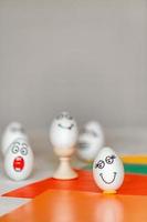 stickers with different emotions are pasted on white eggs, copy space .the concept of communication and emotions in social networks, unusual decoration of easter eggs photo