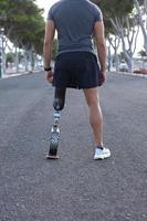 Crop male runner with prosthesis preparing for training photo