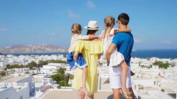 Family in Europe. Parents and kids background the old town in Mykonos island, Greece video