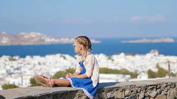 Portrait of adorable little girl background Mykonos town in Europe video