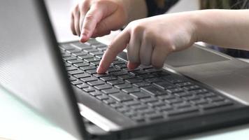 Hands of child on computer keyboard. Close up video