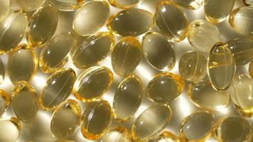 Vitamins D, capsules omega 3, macro video