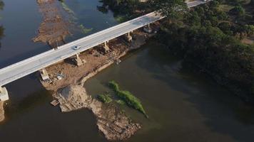 Aerial view of renovation and repair work on the river bridge road. video