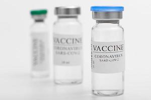 vaccine selection. Ampoules with Covid-19 vaccine in laboratory. to fight the coronavirus sars-cov-2 pandemic. Glass vial medical close-up isolated on a white background. photo