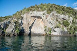 The Maori rock carvings the iconic tourist attraction place in lake Taupo the largest fresh water lake in New Zealand. photo