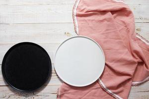 two empty ceramic food trays and a tablecloth on the table top view photo