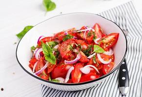 Tomato salad with basil and red onions. Homemade food.  Concept healthy meal. Vegan cuisine. photo