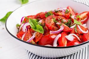 Tomato salad with basil and red onions. Homemade food.  Concept healthy meal. Vegan cuisine. photo