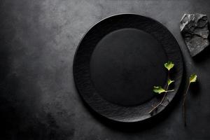 Black plate on stone table top view. Empty space for menu or recipe. photo