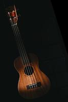 Ukulele on black background photo