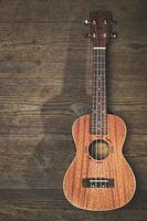 A ukulele resting on wooden slats photo