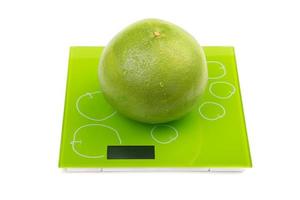 Sweetie fruit on square kitchen scales photo