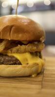 Beef brisket burger which contain bearnaise sauce, tomato, relish, onion rings and mozzarella cheese. photo