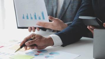 Financial analysts analyze business financial reports on a digital tablet planning investment project during a discussion at a meeting of corporate showing the results of their successful teamwork. video