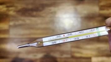 Thermometer shows elevated body temperature 37.7 video