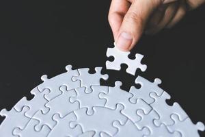 Closeup hand of woman connecting jigsaw puzzle, Business solutions, success and strategy concept. photo