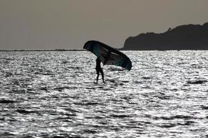 windsurfing, kitesurfing, water and wind sports powered by sails or kites photo