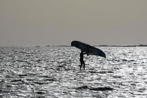 windsurfing, kitesurfing, water and wind sports powered by sails or kites photo