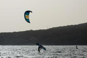 windsurfing, kitesurfing, water and wind sports powered by sails or kites photo