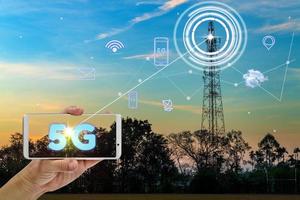 hand holding mobile smart phone using 5G network interface and icon photo