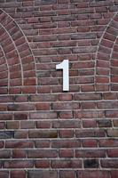 number 1 on brick wall photo