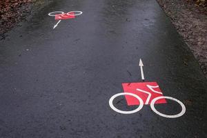 bicycle sign on the road in the rain photo