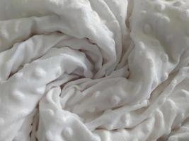 Macro shot of a soft white blanket. photo