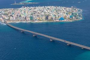 Maldivian capital from above, bridge towards the airport. Aerial view of atoll, cityscape. Travel landscape photo