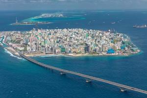 Maldivian capital from above, bridge towards the airport. Aerial view of atoll, cityscape. Travel landscape photo