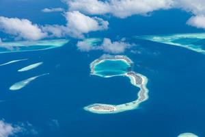 Aerial view of coral reefs in Maldives islands. Tropical aerial landscape. Luxury summer vacation and travel destination photo
