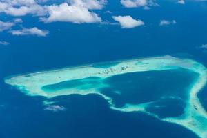 Aerial view of coral reefs in Maldives islands. Tropical aerial landscape. Luxury summer vacation and travel destination photo