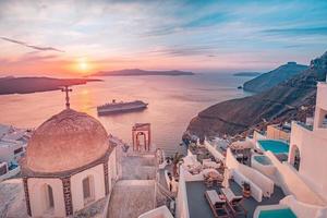 Great evening view of Santorini island. Picturesque spring sunset on the famous Greek resort Fira, Greece, Europe. Traveling concept background. Beautiful sunset landscape of famous vacation scenery photo