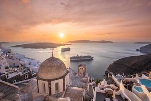 Great evening view of Santorini island. Picturesque spring sunset on the famous Greek resort Fira, Greece, Europe. Traveling concept background. Beautiful sunset landscape of famous vacation scenery photo