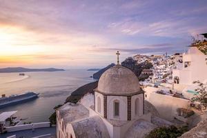 Great evening view of Santorini island. Picturesque spring sunset on the famous Greek resort Fira, Greece, Europe. Traveling concept background. Beautiful sunset landscape of famous vacation scenery photo