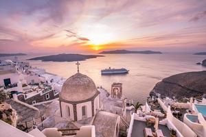 Great evening view of Santorini island. Picturesque spring sunset on the famous Greek resort Fira, Greece, Europe. Traveling concept background. Beautiful sunset landscape of famous vacation scenery photo