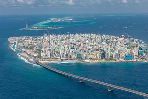 Maldivian capital from above, bridge towards the airport. Aerial view of atoll, cityscape. Travel landscape photo